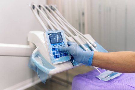Téléchargez les photos : Stock photo of faceless dentist using medical equipment in dental clinic. - en image libre de droit