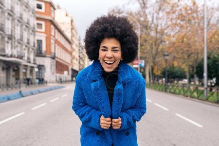 Photo for Stock photo of young afro woman laughing and looking at camera. - Royalty Free Image