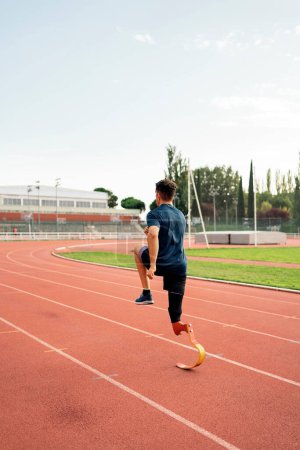Photo for Stock photo of young athlete training with leg prosthesis in running track. - Royalty Free Image