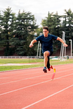 Photo for Stock photo of young athlete training with leg prosthesis in running track. - Royalty Free Image