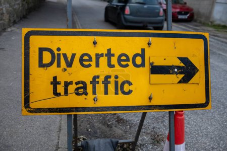diverted traffic sign in yellow and black 