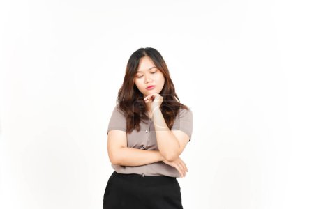 Photo for Sad looking Asian woman is seen looking down and deep in thought with a white background - Royalty Free Image