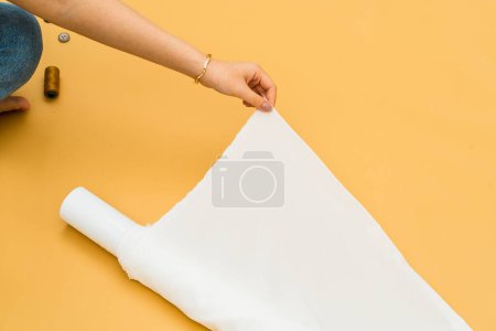 Photo for In a minimalistic ambiance, the mockup of a white fabric roll image exudes an understated sense of luxury - Royalty Free Image