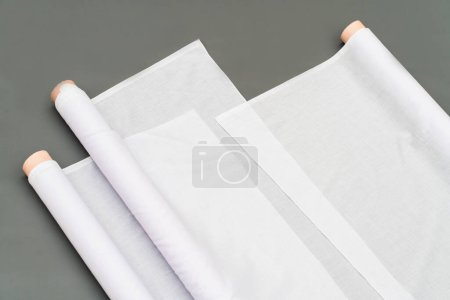 Photo for A mockup featuring a white fabric roll image is effortlessly integrated into the minimalistic set up, evoking an air of sophistication - Royalty Free Image