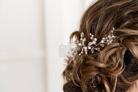 Téléchargez les photos : Close-up of the bride's hairstyle. Curls. Jewelry with pearls for hair. Wedding ceremony. Preparation of the bride. Hairstylist - en image libre de droit