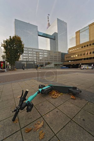 Photo for Brussels, Brabant, Belgium 10 28 2022 Vertical wide angle on a electronical rechargeable limebike step on pavement with skyscrapers in the background - Royalty Free Image