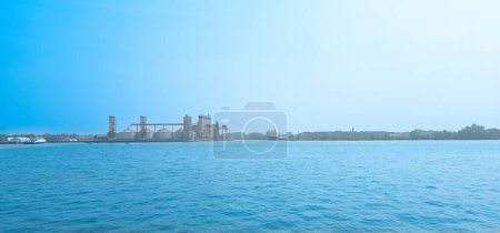 Photo for Industrial port, industrial construction, crane in blue sky - Royalty Free Image