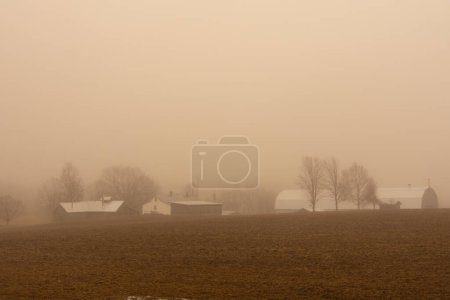 Photo for The landscape of the Canadian countryside in Quebec on a foggy day - Royalty Free Image