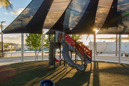 Photo for View of children's playground with slide in Key West (Spanish: Cayo Hueso) is an island in the Straits of Florida - Royalty Free Image