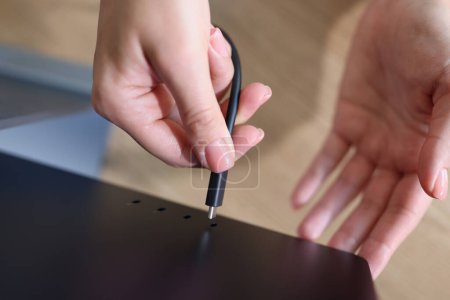 Photo for Top view of woman hands connecting laptop screen using cable. Female inserting plug to monitor. Equipment setup concept - Royalty Free Image