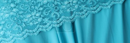 Photo for Delicate light blue guipure lace fabric on blue satin fabric. Texture fabric background concept - Royalty Free Image