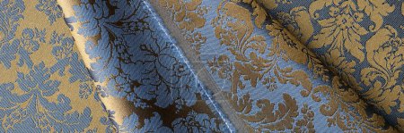 Draufsicht auf blauen Stoff mit goldenem Blumenmuster und nahtlosem Hintergrund. Textur Tuch Hintergrundkonzept