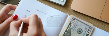 Photo for Close-up of woman counting money and making notes in notepad. Earned money, savings and earnings. Making every day counts concept - Royalty Free Image