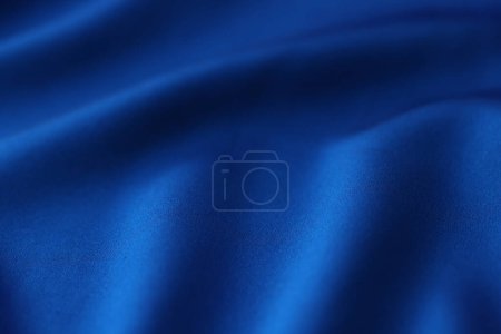 Wavy blue plain satin fabric as background. Luxury textile material for dressmaking and sewing. Organic silk sample in tailor store