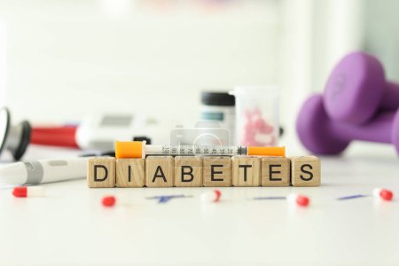 Photo for Text Diabetes on wooden cubes with syringe and pills blister on table. Endocrine system disease caused by high blood sugar levels. Insulin shot for cure - Royalty Free Image