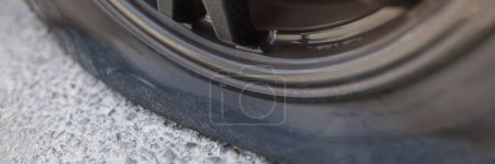 Photo for Flat car tire closeup and punctured wheel. Road wheel repair - Royalty Free Image