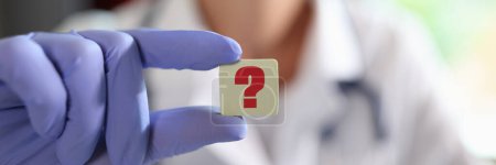 Photo for Question mark in hand of general practitioner or cardiologist in clinic. Online doctor consultation and ask medical question to doctor - Royalty Free Image