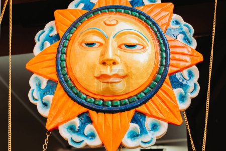 Photo for Wooden handicraft of a Sun God kept for sale in Kathmandu. - Royalty Free Image