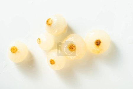 marinated small grilled onions on a white background