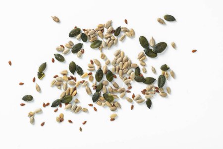 Foto de Varias calabaza y girasol, semillas de lino sobre un fondo blanco - Imagen libre de derechos