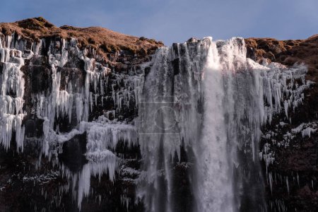 paysage d'une énorme cascade enneigée et glacée avec ciel bleu et paysages d'automne