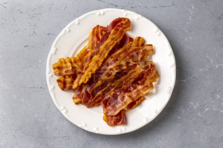 Photo for Delicious fried bacon served on plate. - Royalty Free Image