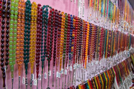 Photo for Selectively focused on the Prayer beads in different colors. Close-up pictures of tesbih in Turkey. View of tesbih - tespih hanging in the street shop in Kemeralti - Izmir - Turkey - Royalty Free Image