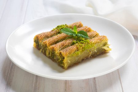 Photo for Turkish famous dessert burma kadayif on plate with pistachio - Royalty Free Image