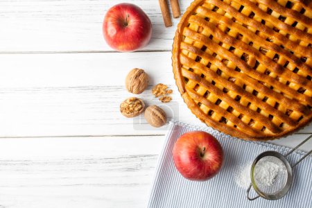 Photo for Homemade Apple Pies on a white wooden background, top view. The classic fall Thanksgiving dessert - organic apple pie. - Royalty Free Image