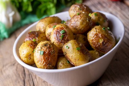 Photo for Roasted baked baby potatoes with garlic and herbs. - Royalty Free Image