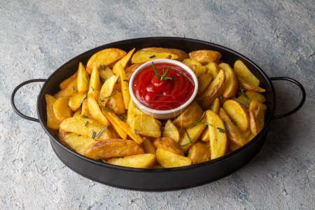 Photo for Roasted potato wedges with herbs and sea salt on plate, top view (Turkish name; elma dilim patates) - Royalty Free Image