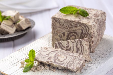 Photo for Halva dessert with sesame paste and cacao on white. Turkish name; helva - Royalty Free Image