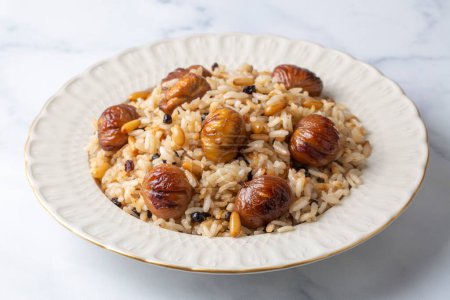 Photo for Traditional delicious Turkish food; chestnut rice pilaf (Turkish name; kestaneli pilav) - Royalty Free Image