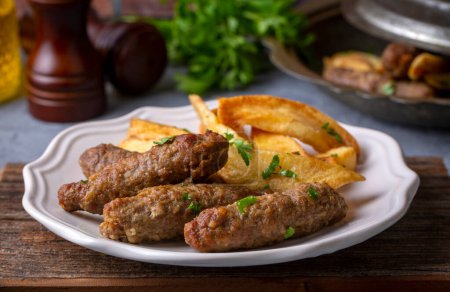 Photo for Traditional Turkish food; dry meatballs or inegol meatballs with potatoes (Turkish name; Kuru kofte or anne koftesi) - Royalty Free Image