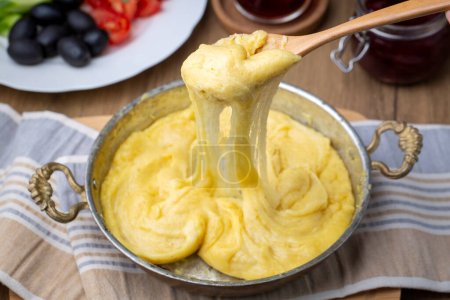 Mihlama (kuymak) is a famous traditional food from Black Sea region in Turkey. It is prepared with corn meal and cheese and served hot.