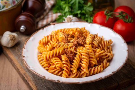 Photo for Fusilli pasta, spiral or spirali pasta with tomato, minced sauce - Italian food style - Royalty Free Image