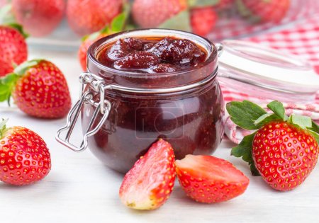 Photo for Homemade delicious strawberry jam and strawberry on a rustic wooden table - Royalty Free Image