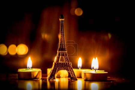 Photo for Small eiffel tower figure and candles - Royalty Free Image