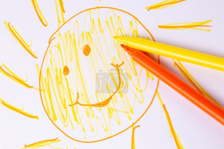 Photo for Smiley sun drawn on paper with colored paints - Royalty Free Image