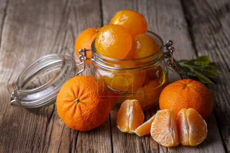 Téléchargez les photos : Confiture de mandarine dans un pot en verre avec des fruits autour - en image libre de droit