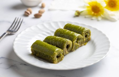 Photo for Pistachio baklava. Traditional Middle Eastern Flavors. The local name of Baklava is Fistikli Baklava or fistikli dolama. Turkish style pistachio baklava presentation and service - Royalty Free Image