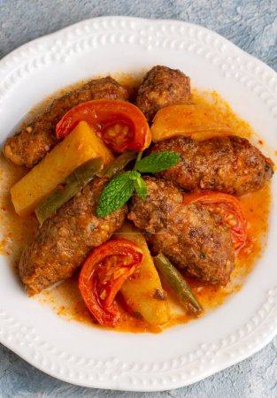 Photo for Traditional Homemade Turkish Food Kofte - Kofta with Tomato Sauce and Potatoes. (Turkish name; Izmir kofte) - Royalty Free Image