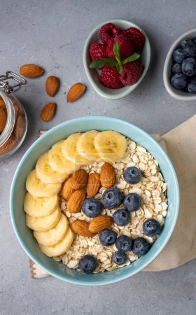 Photo for Oatmeal. With banana, blueberry and almond for healthy breakfast or lunch. Healthy diet nutrition. - Royalty Free Image