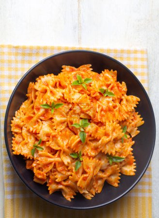 Photo for Farfalle pasta with tomato sauce, bow tie pasta tomatoes sauce (Turkish name; domatesli kelebek makarna) - Royalty Free Image
