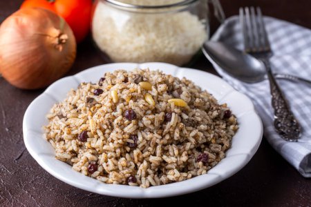 Photo for Traditional delicious Turkish food; rice pilaf with pine nuts and currants (Turkish name; ic pilav or pilaf) - Royalty Free Image