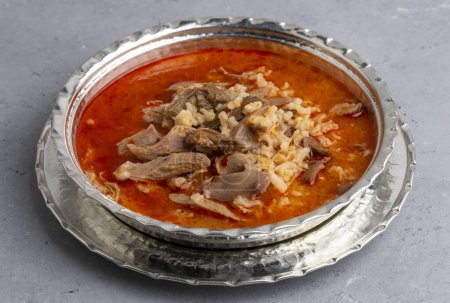 Photo for Turkish Soup Beyran with Lamb Meat, Rice, Chopped Garlic and Vinegar Sauce. Traditional Organic Food. Traditional soup of Gaziantep, Turkey. (Turkish name; Beyran corbasi) - Royalty Free Image