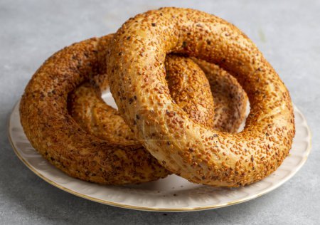 Photo for Turkish fast food bagel called Simit. Turkish bagel Simit with sesame. Bagel is traditional Turkish bakery food. - Royalty Free Image