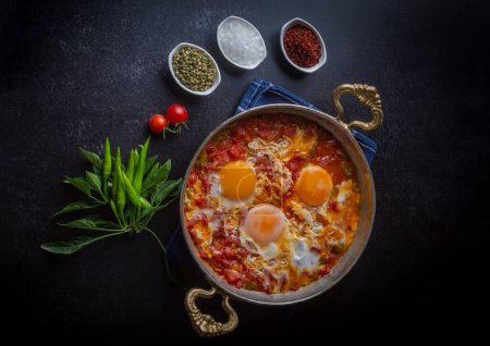 Photo for Famous Turkish menemen dinner on table, made by eggs, pepper and tomatoes. - Royalty Free Image