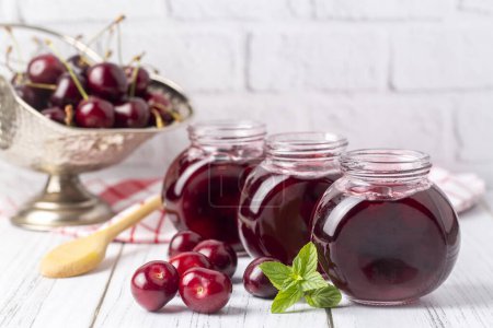Photo for Fresh organic cherries - cherries and cherries in jars - sour cherry jam - Royalty Free Image