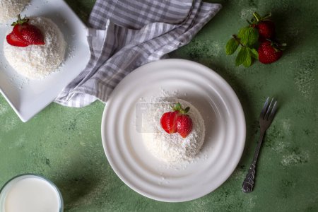 Photo for Delicious milk dessert; cup dessert with coconut and strawberry (Turkish name; fincan tatlisi - Royalty Free Image